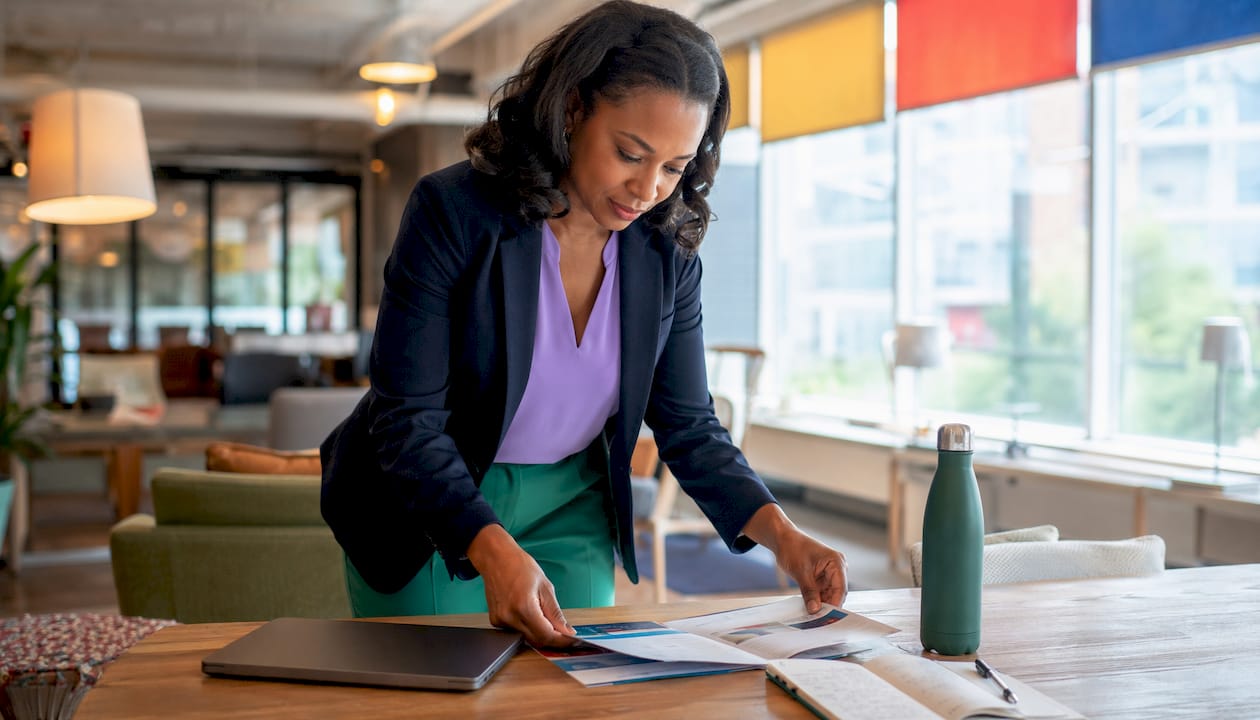 Professional reviewing Microsoft 365 Copilot alternatives brochures